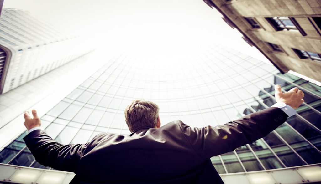 A man looking in joy in front of the coprate office 