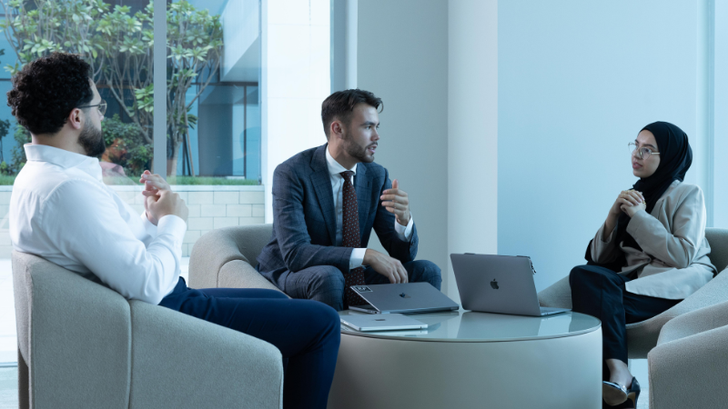 A diverse group of co-founders and their investors, including men and women of different ethnicities, celebrate their successful company registration with joy and excitement.