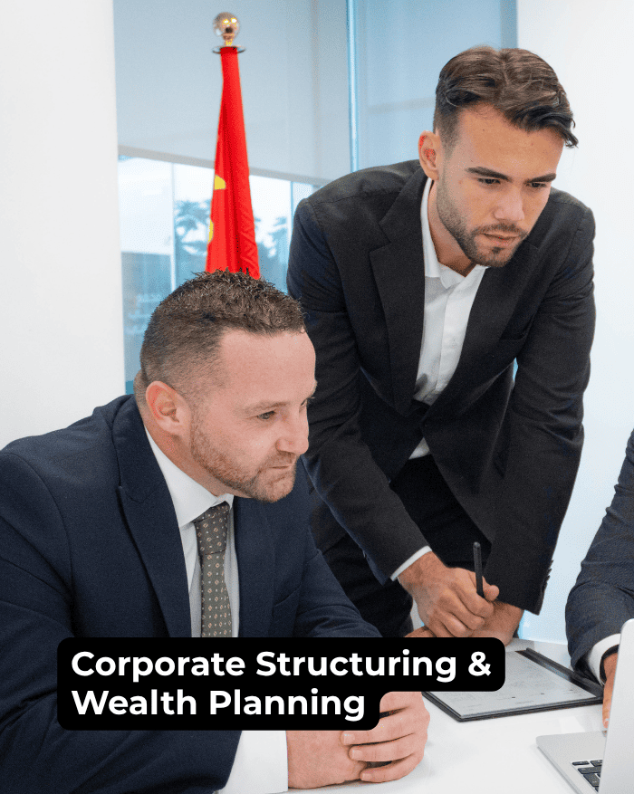 Corporate legal advisors discussing corporate structuring and wealth planning strategies