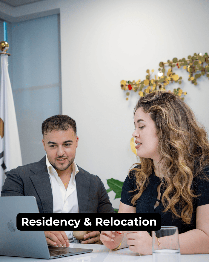 Two business professionals in a consultation meeting with a banner reading Residency and Relocation