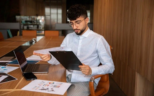 A focused professional analyzing VAT metrics