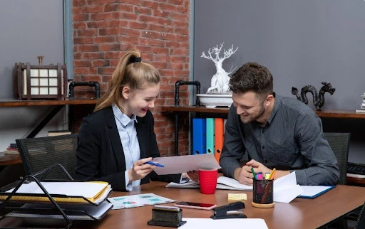 Business consultants reviewing company documents during a UAE business setup and tax advisory meeting