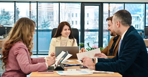 Business consultants meeting with clients to discuss company setup strategy and financial documents in a modern office