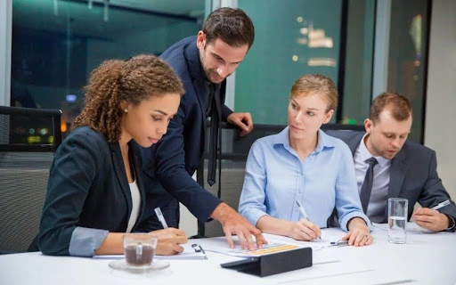 A team of diverse professionals in a boardroom collaborating over delaware business setup documents
