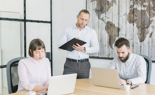Two entrepreneurs working on laptops symbolizing professional guidance for US business setup