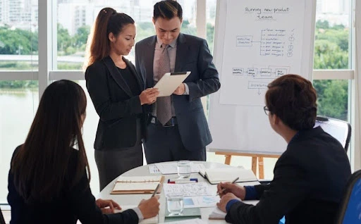 A diverse team of business professionals in a modern office discussing cayman islands company formation