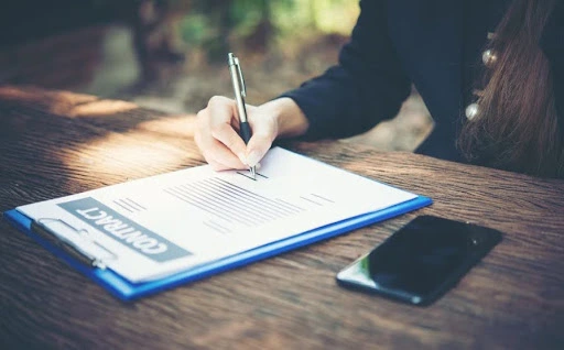 Close-up of a business professional signing a commercial contract