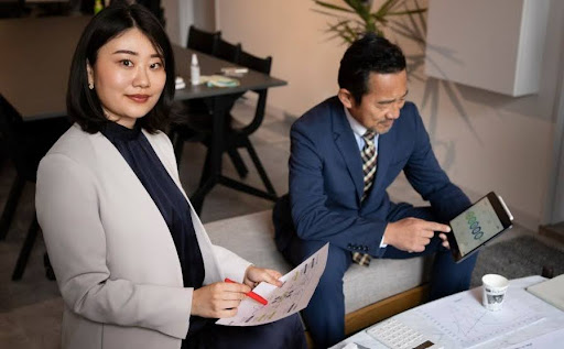 Two business professionals reviewing company registration data