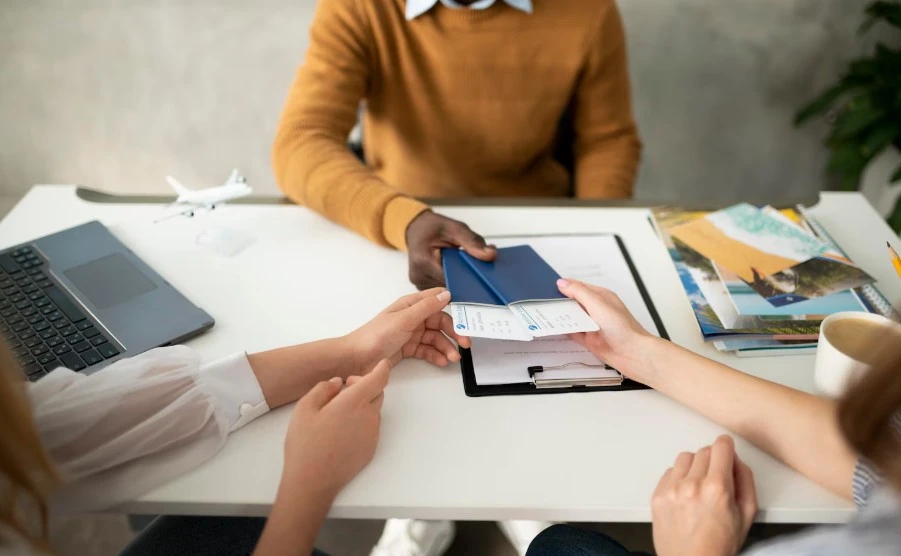 professional handing over passports and flight boarding passes to a client