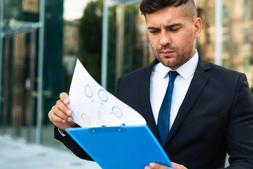 A man in professional suiting looking into a file mentioning VAT penalties UAE