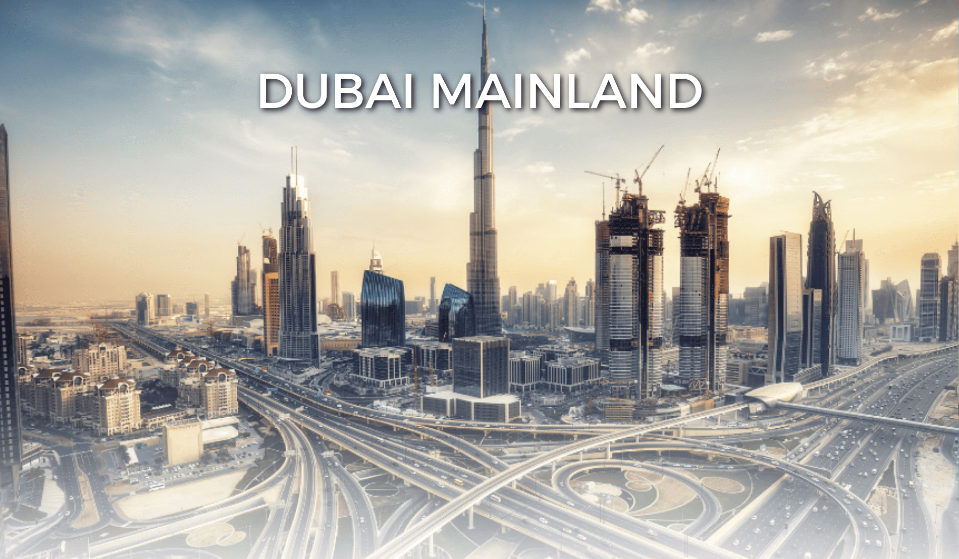Aerial view of the Dubai city skyline with text overlay reading Dubai Mainland