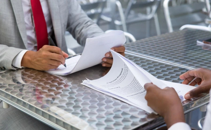 Two professional discussing related to no objection certificate in UAE