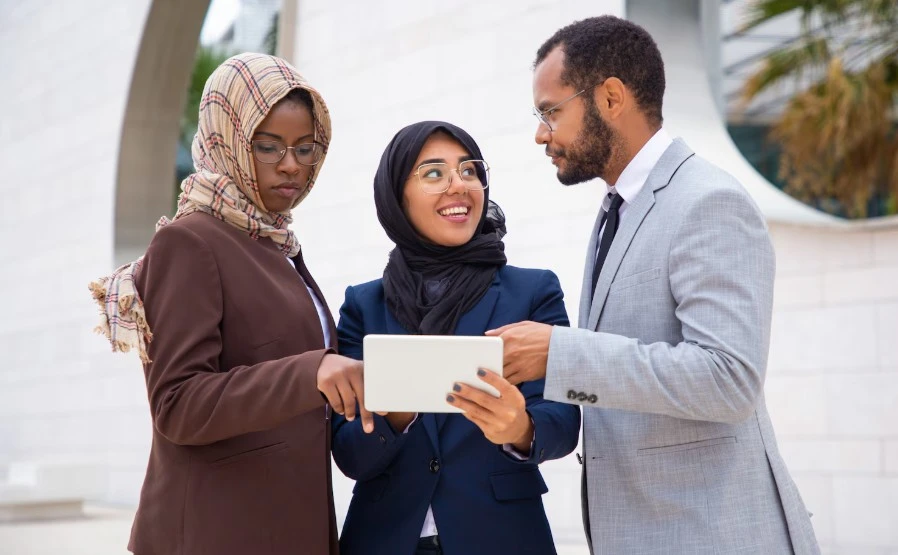 Three persons consulting on starting a business in the uae