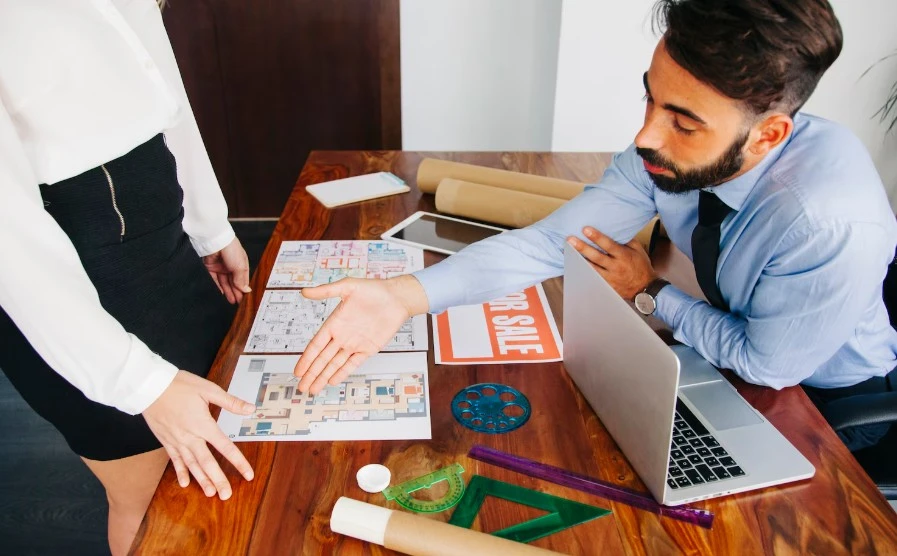 Business professional pointing his hand towards a place in map