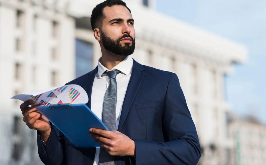 Low angle business man with clipboard