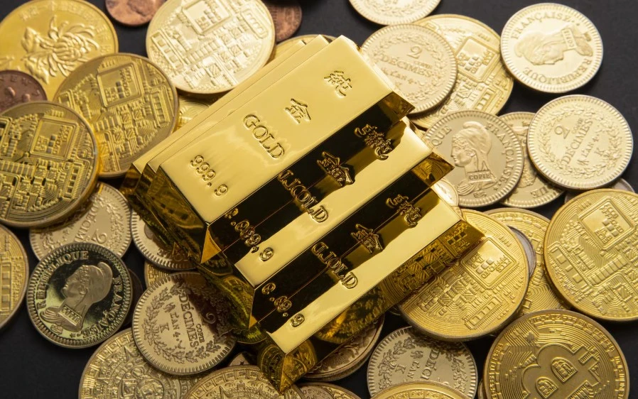 Closeup shot of a pile of shiny gold coins and bars