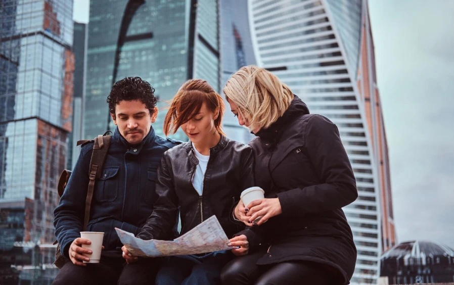 three people watching the map