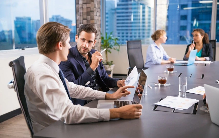 Business consultants on a long wooden table