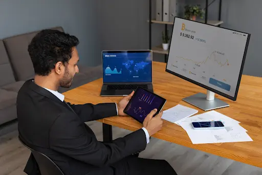 man watching crypto trend on computer screen